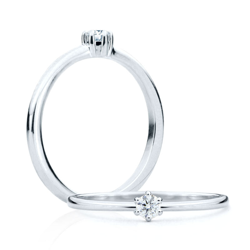 
                  
                    6 prongs engagement ring mounting adorned with a 0.10ct round diamond Josie Solitaire Engagement ring in 18Kt solid white gold.
                  
                